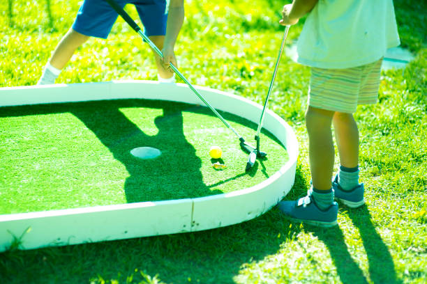 istock Kids playing golf on a sunny day 1155649642