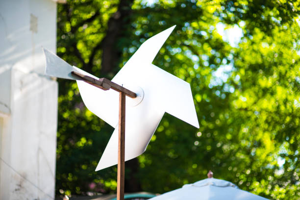 istock Paper windmills in green grass field 1155649657