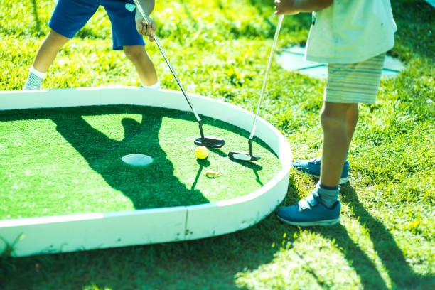 istock Kids playing golf on a sunny day 1155649672