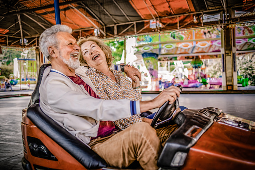 senior couple having fun together in the amusement park