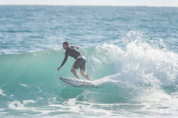 istock Solo male surfer in Hawaii catching a wave 1155650129
