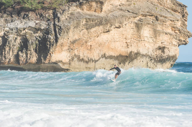 istock Solo male surfer in Hawaii dropping in 1155650132
