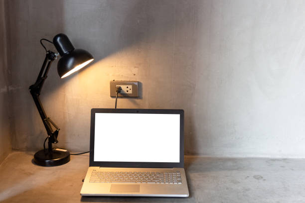 istock laptop with blank white screen for mock up template background on Table 1155652086