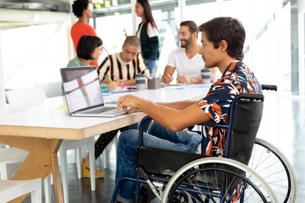istock Disabled businessman using laptop in the conference room 1155652316