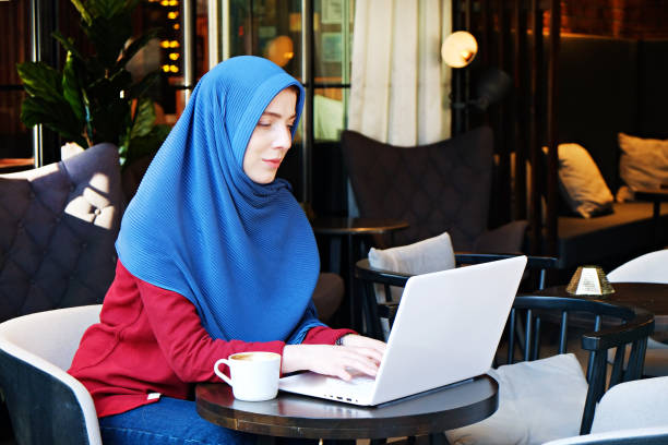 istock Young muslim woman at hip coffee place. 1155653095
