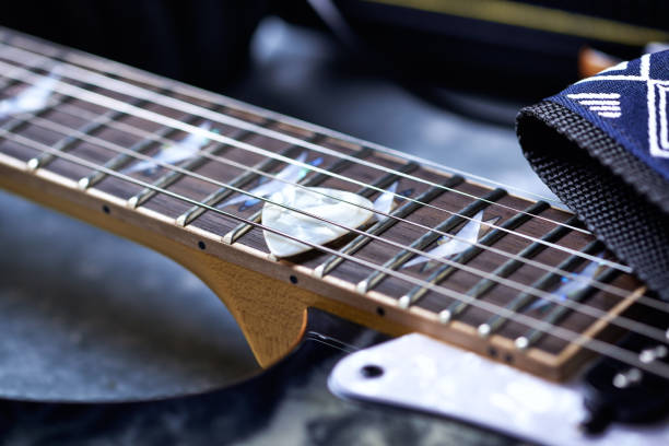 istock Electric guitar close up. Wooden background. 1155654723