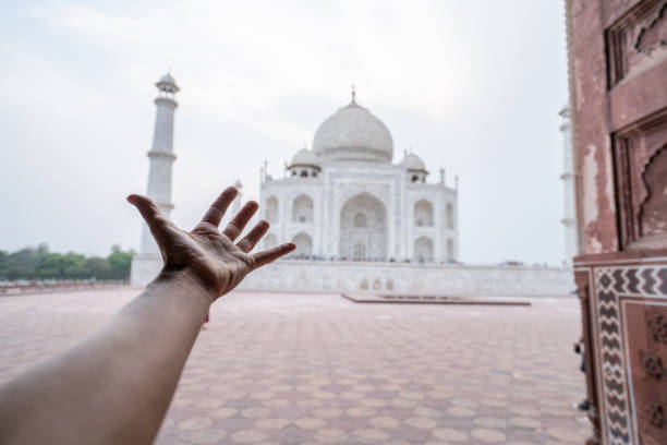 istock Hand stretching towards the Taj Mahal 1155657779
