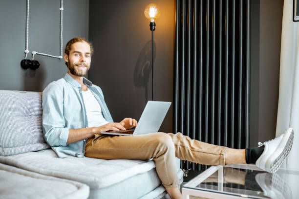istock Man with laptop at home 1155660162