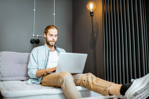 istock Man with laptop at home 1155660197