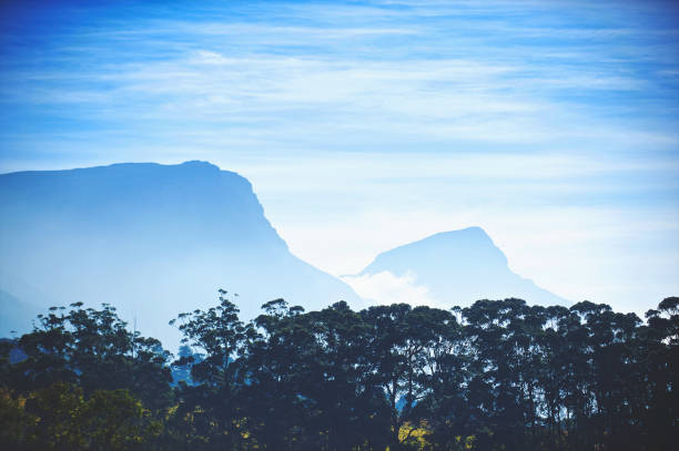 Serene landscape featuring rolling green hills, vibrant vegetation, and a partly cloudy sky, evoking a sense of peace and natural beauty in an untouched countryside setting.