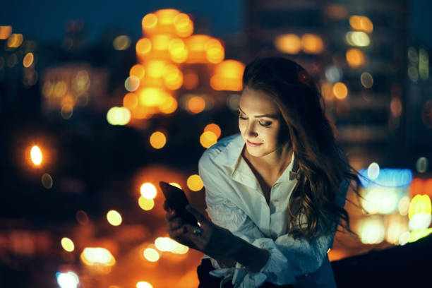 istock Woman over cityscape holding a smart phone texting 1155661071