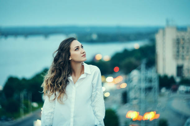 A portrait of a beautiful young woman while the sun is setting.