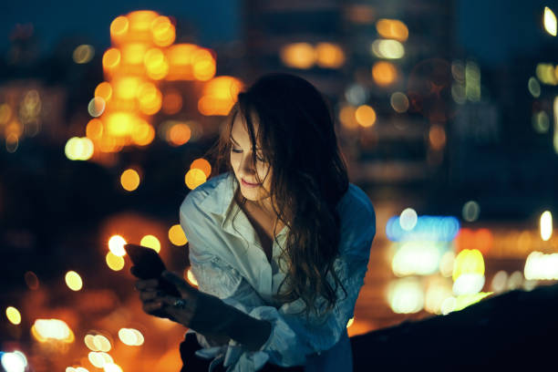istock Woman over cityscape holding a smart phone texting 1155661319