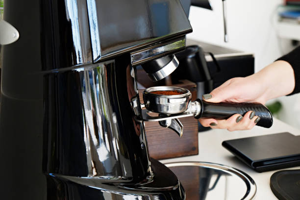 istock Hands of barista making coffee. 1155662616