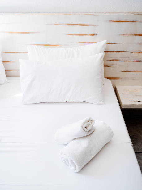 istock Clean towels on bed at hotel room 1155663242