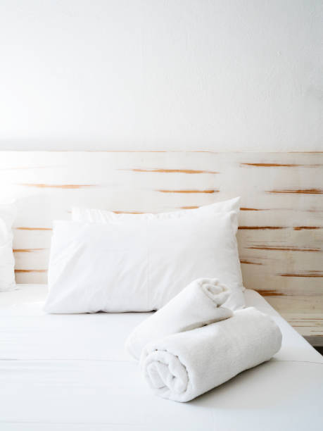 istock Clean towels on bed at hotel room 1155663400