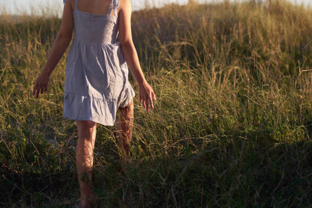 istock long grass carefree woman 1155664290