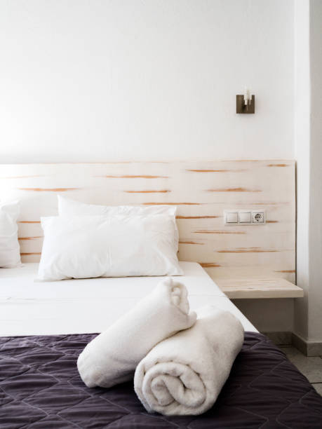 istock Clean towels on bed at hotel room 1155664606