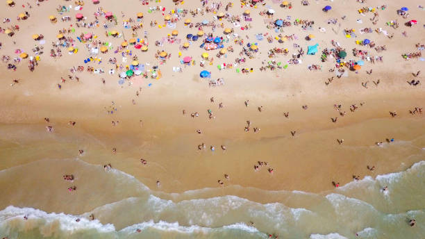 istock Crowded public beach with colourful umbrellas 1155664624
