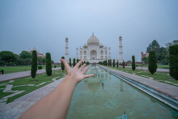 istock Hand stretching towards the Taj Mahal 1155664846
