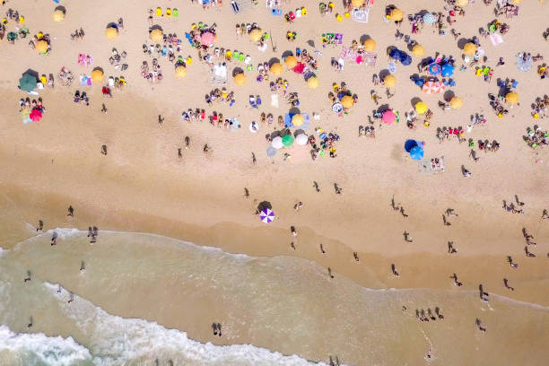 istock Crowded public beach with colourful umbrellas 1155665258