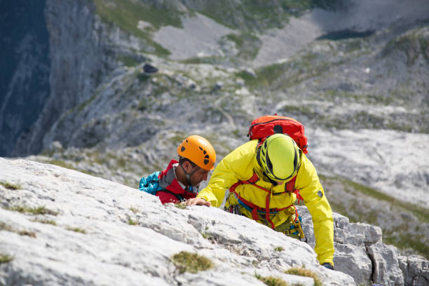 istock Two men climbing mountains close-up 1155666168