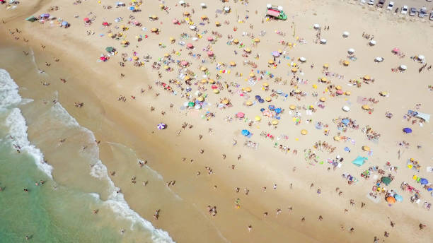 istock Crowded public beach with colourful umbrellas 1155666531