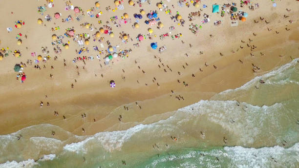 istock Crowded public beach with colourful umbrellas 1155666642