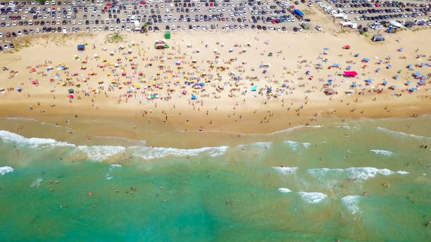 istock Crowded public beach with colourful umbrellas 1155666942