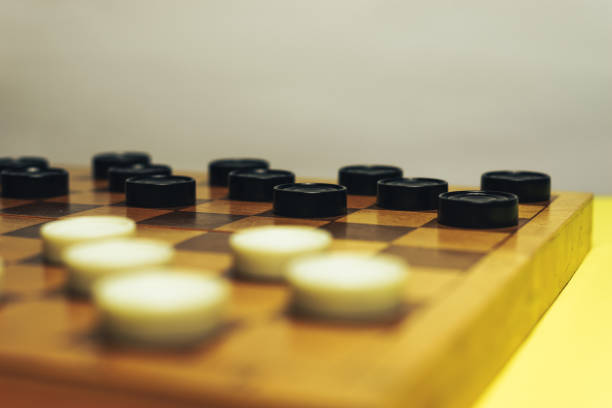 istock Chess baord with chess on a yellow table background. 1155667028