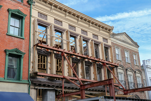 Charleston, SC – February 9, 2019: The façade of an old building on King Street is braced for support during construction of a new interior.
