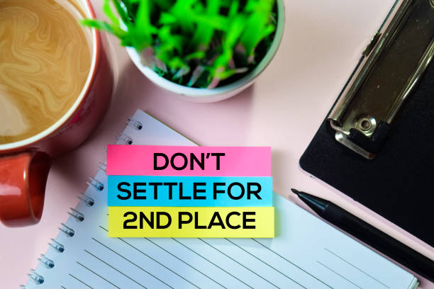 istock Don't Settle for 2nd Place text on sticky notes with office desk concept 1155668174