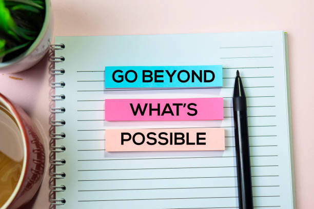 istock Go Beyond What's Possible text on sticky notes with office desk concept 1155668314
