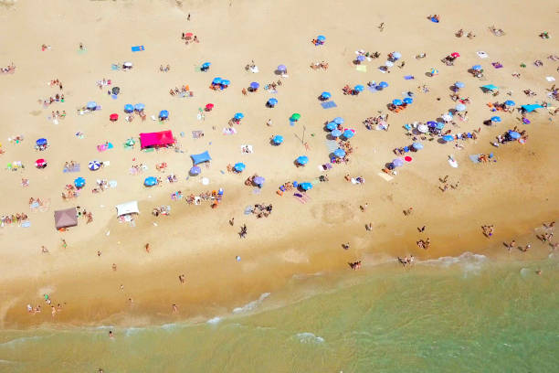 istock Crowded public beach with colourful umbrellas 1155668439