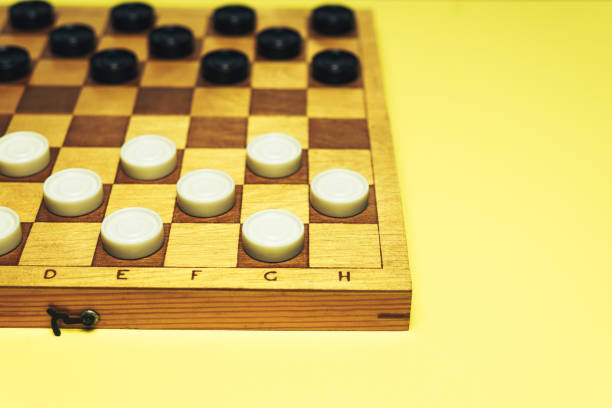 istock Chess baord with chess on a yellow table background. 1155668799