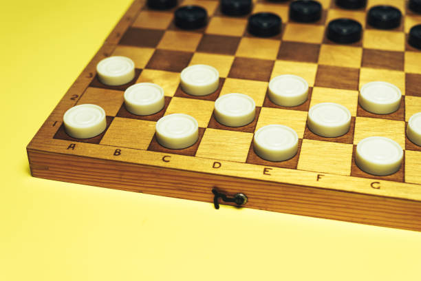 istock Chess baord with chess on a yellow table background. 1155668958