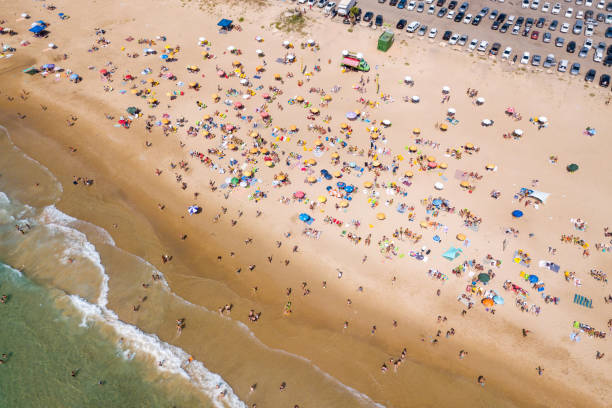 istock Crowded public beach with colourful umbrellas 1155668985