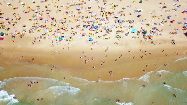 istock Crowded public beach with colourful umbrellas 1155669072