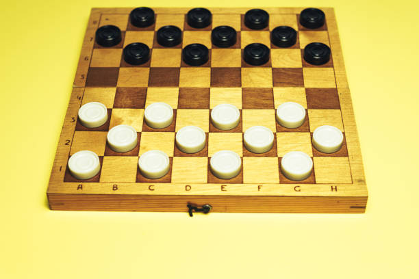 istock Chess baord with chess on a yellow table background. 1155669261