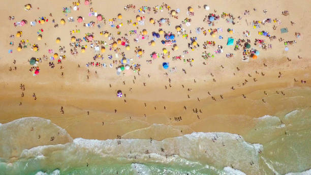 istock Crowded public beach with colourful umbrellas 1155669625