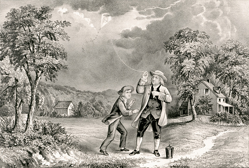 Vintage illustration shows Benjamin Franklin flying a kite during a thunderstorm and collects ambient electrical charge in a Leyden jar, enabling him to demonstrate the connection between lightning and electricity.