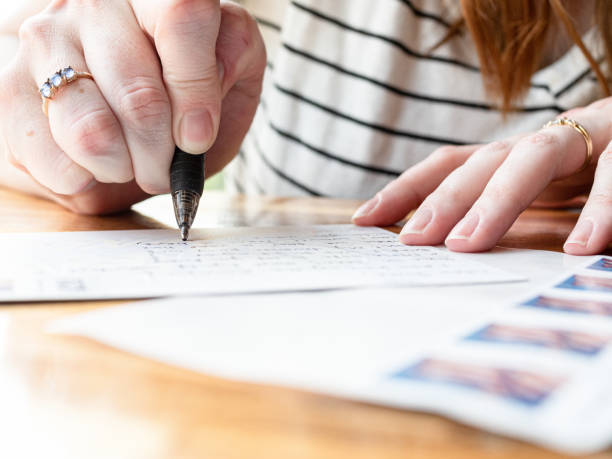 Woman Writing on a Postcard