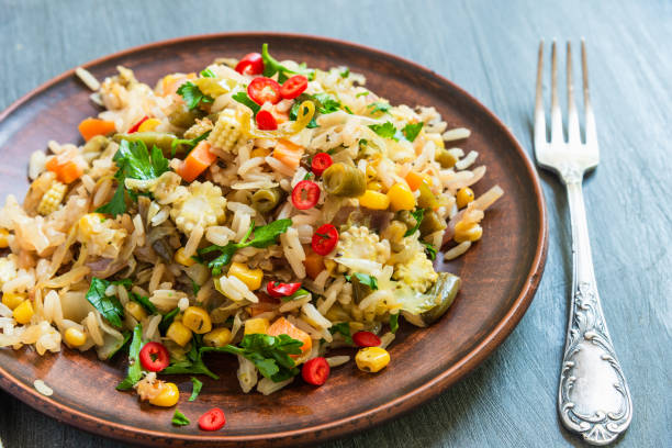 istock Fried vegetarian rice with carrots, corn, onions, beans and pepper with chopped parsley and chili - Indian and Asian cuisine 1155673521
