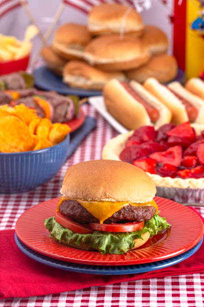 istock Grilled Cheeseburger on a Table Set for an American BBQ with Red White and Blue 1155674086