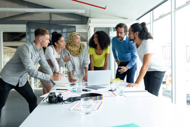 istock Business people interacting with each other at conference room in a modern office 1155675047