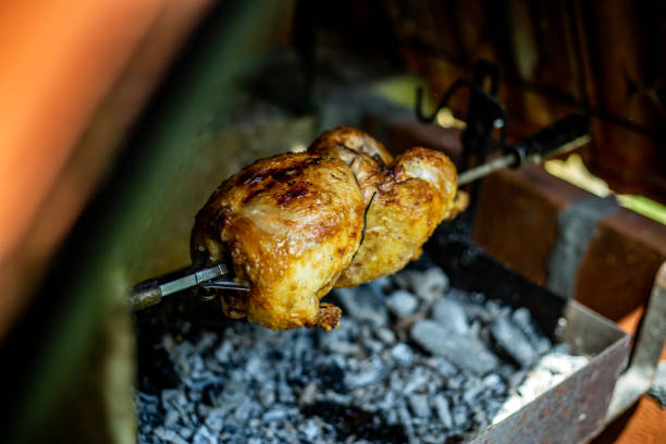 roast chicken on the bbq - chicken rotisserie roast chicken barbecue grill imagens e fotografias de stock