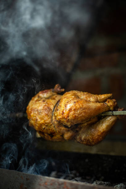 roast chicken on the bbq - chicken rotisserie roast chicken barbecue grill imagens e fotografias de stock