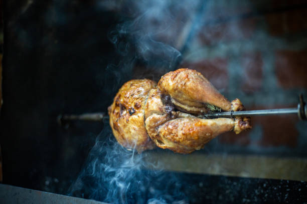 roast chicken on the bbq - chicken rotisserie roast chicken barbecue grill imagens e fotografias de stock