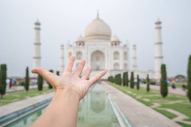 istock Hand stretching towards the Taj Mahal 1155678711