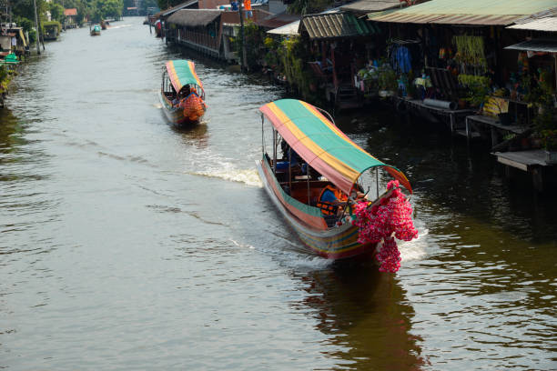 istock Long tail boats are sailing in canal 1155683152